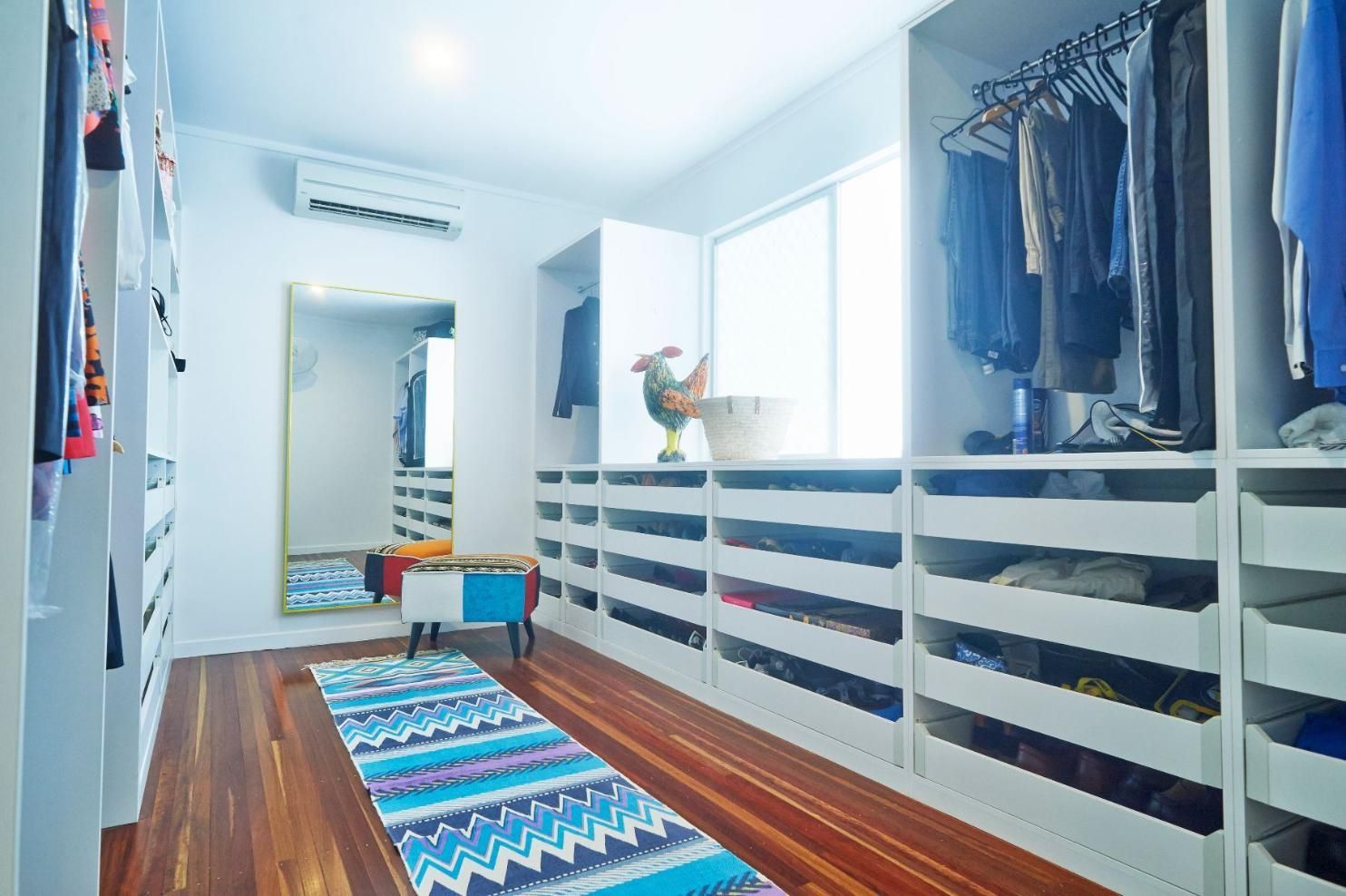 A Walk in Closet Filled With Lots of Clothes and a Rug — Pro-Jax Pty Ltd in Bohle, QLD