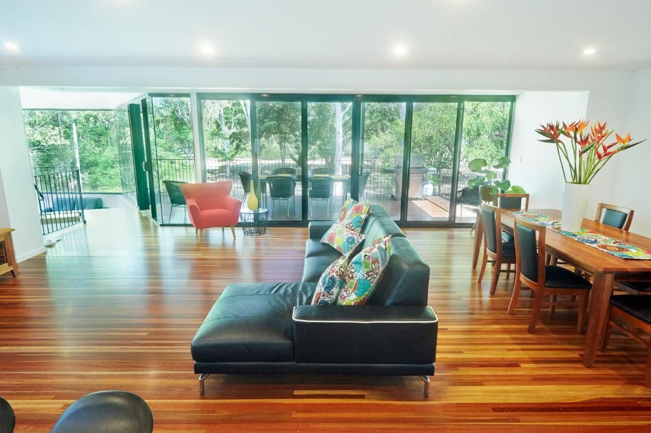 A Living Room With a Couch, Chairs, a Table and a Lot of Windows — Pro-Jax Pty Ltd in Bohle, QLD