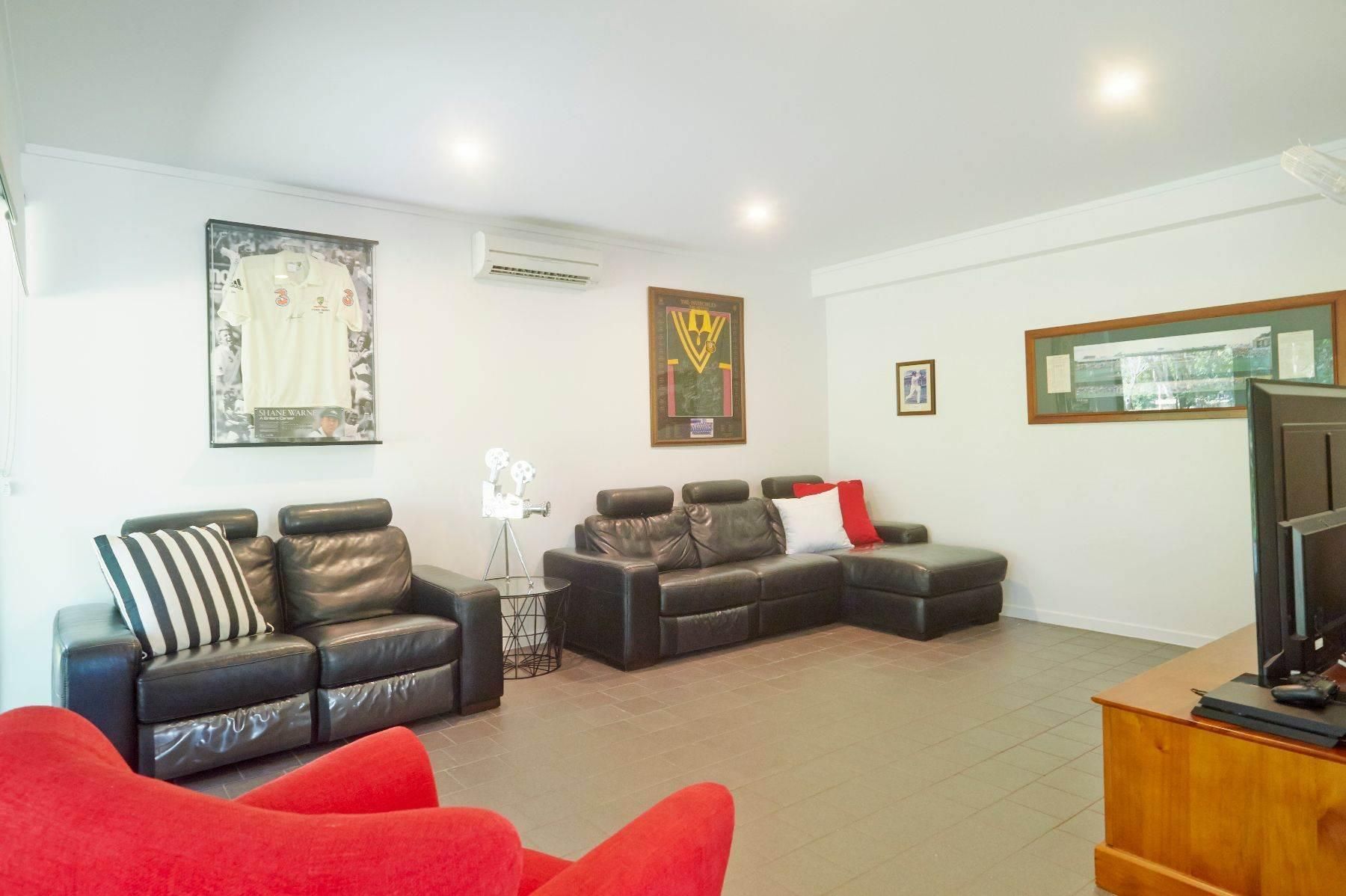 A Living Room Filled With Furniture and a Television — Pro-Jax Pty Ltd in Bohle, QLD