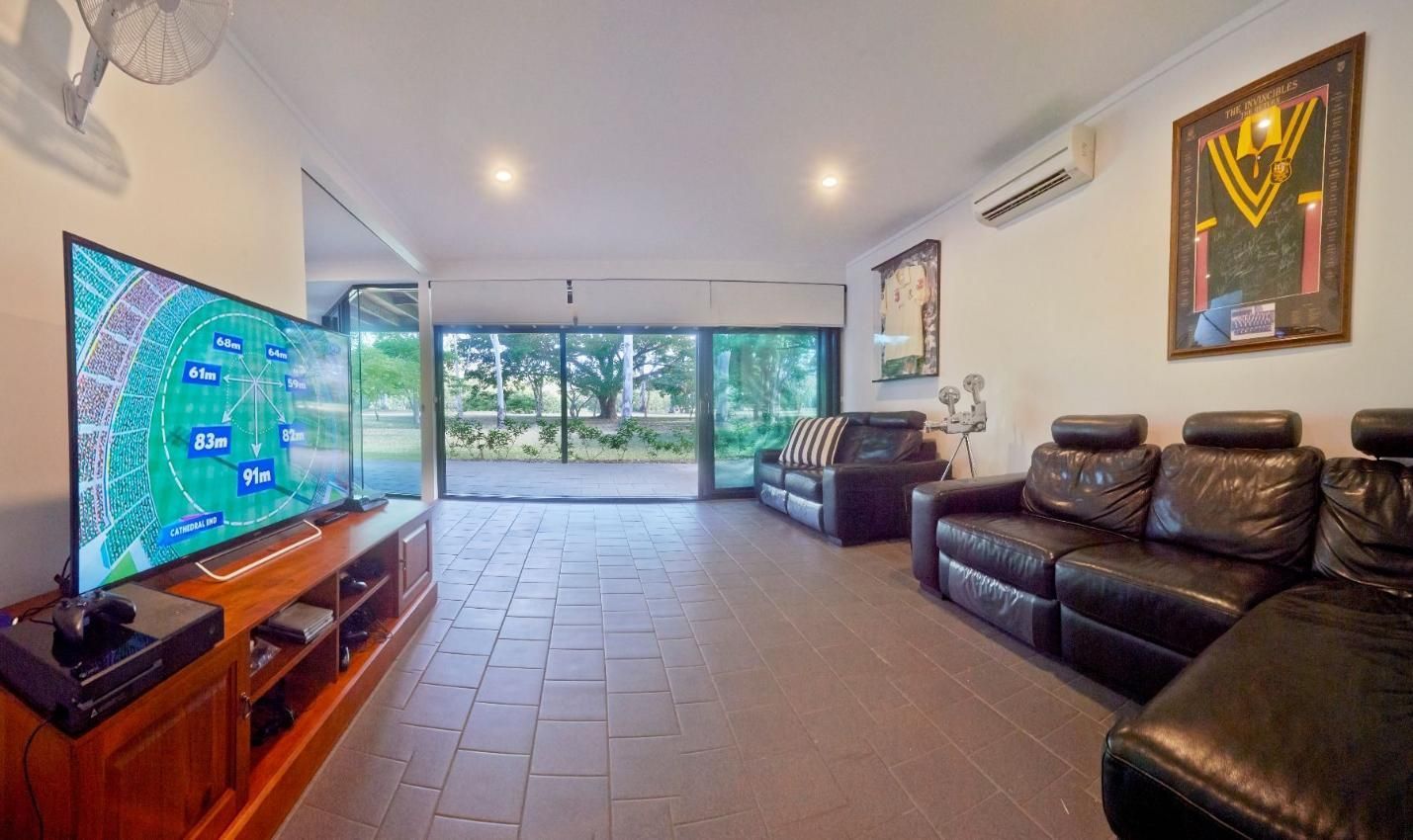 A Living Room Filled With Furniture and a Flat Screen Tv — Pro-Jax Pty Ltd in Bohle, QLD