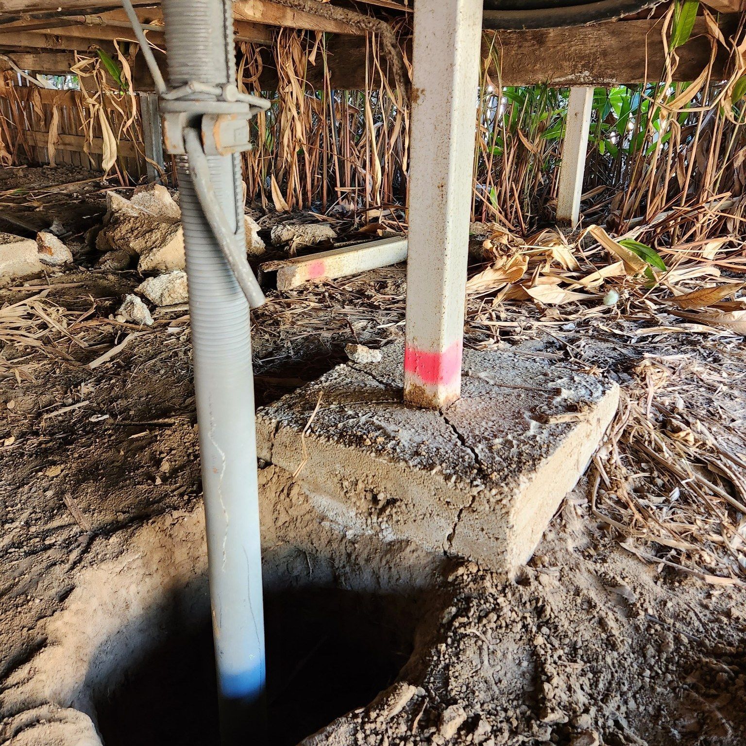 Under a Building: a Supporting Jack Prop and a Concrete Pier in a Dirt Crawlspace — Pro-Jax Pty Ltd in Bohle, QLD