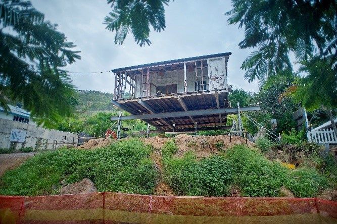 An Elevated, Dilapidated Wooden Structure on a Hillside With Exposed Framing — Pro-Jax Pty Ltd in Bohle, QLD