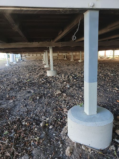 View From Under a Raised Structure Supported by Concrete Piers and Metal Posts — Pro-Jax Pty Ltd in Bohle, QLD