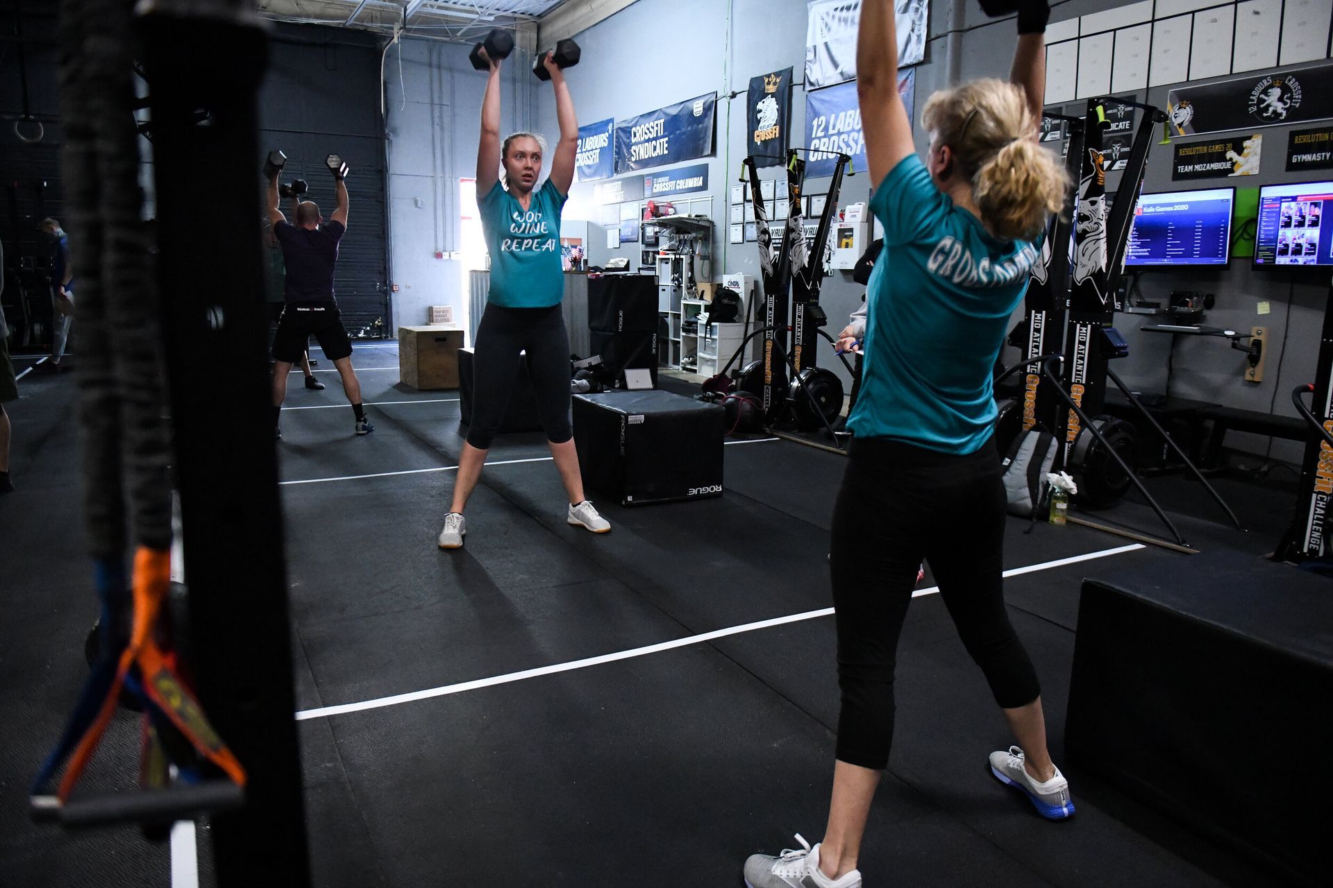 A group of people are doing exercises in a gym.