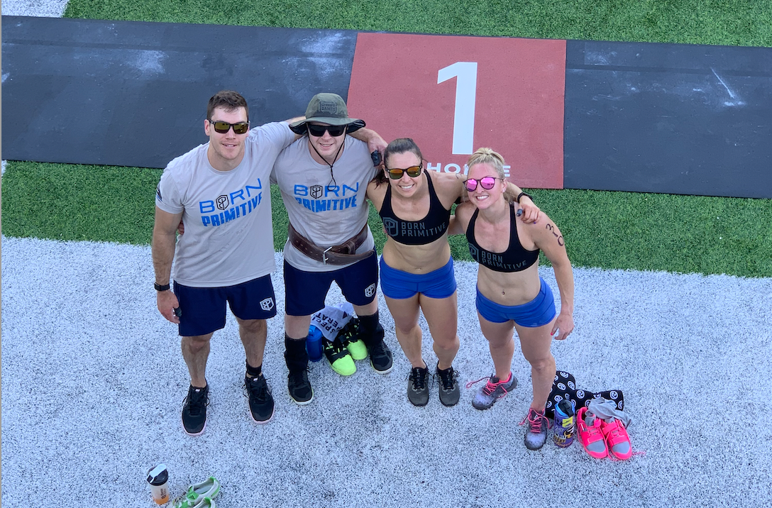 A group of people are posing for a picture on a field.