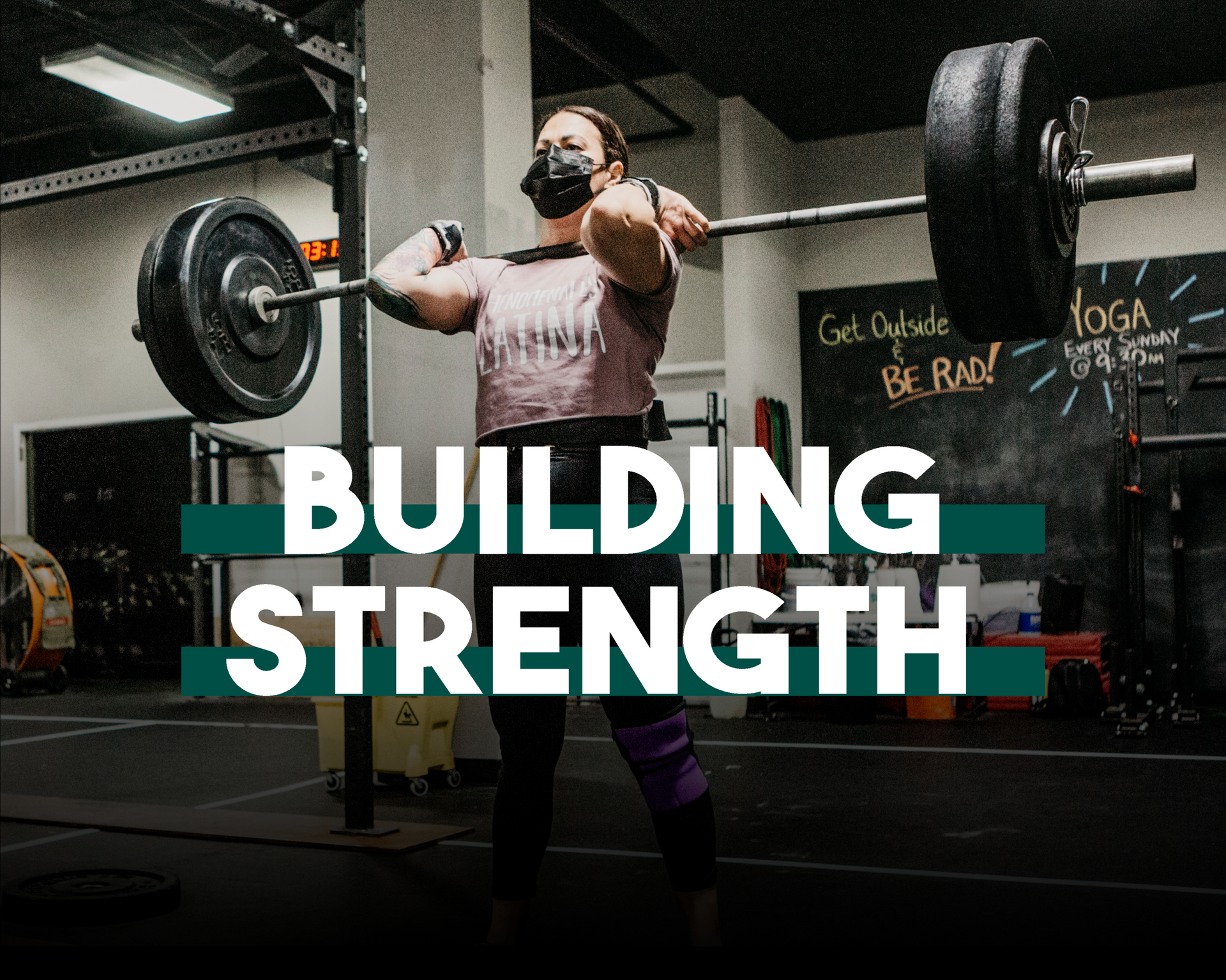 A woman wearing a mask is lifting a barbell in a gym.