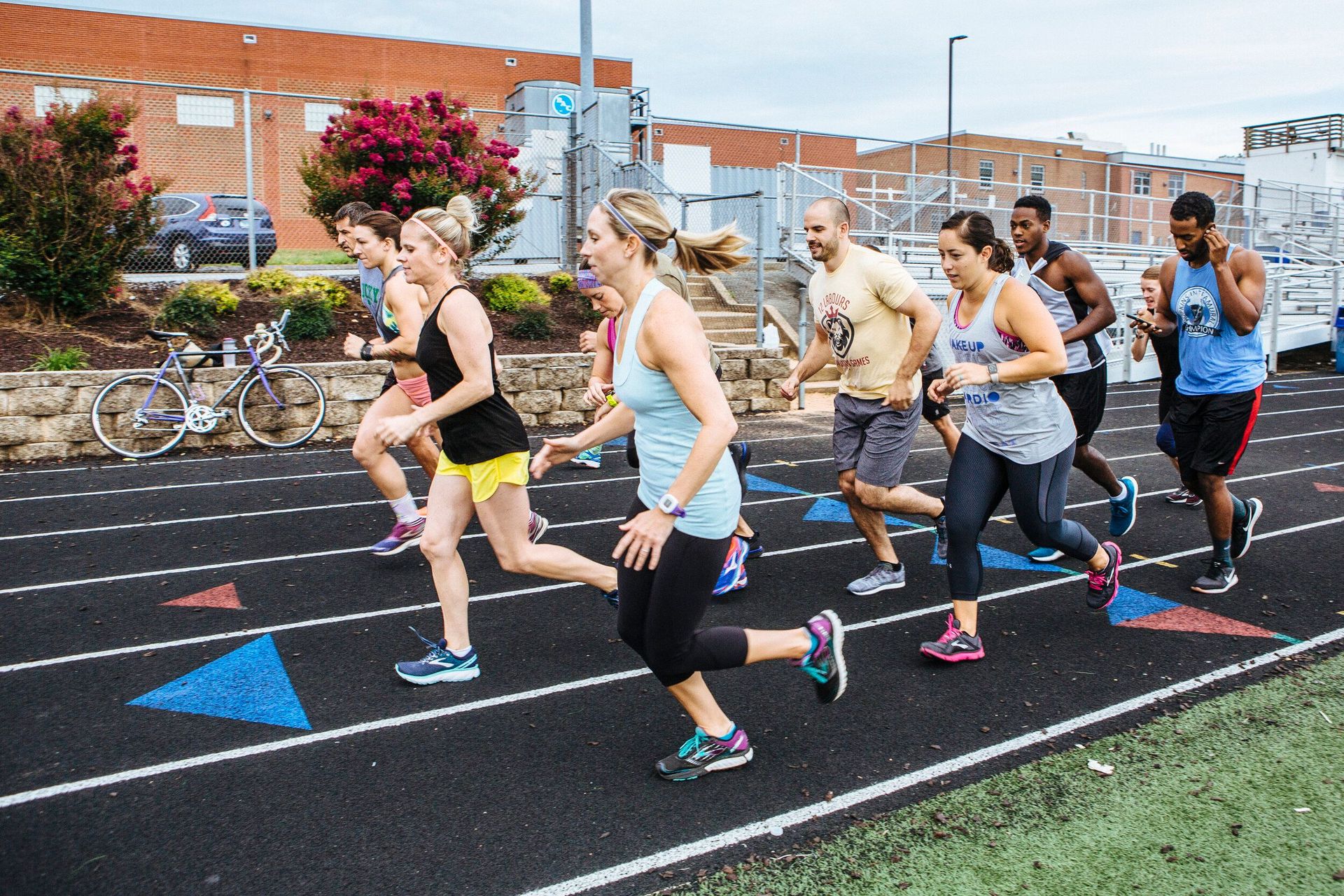 A group of people are running on a track.