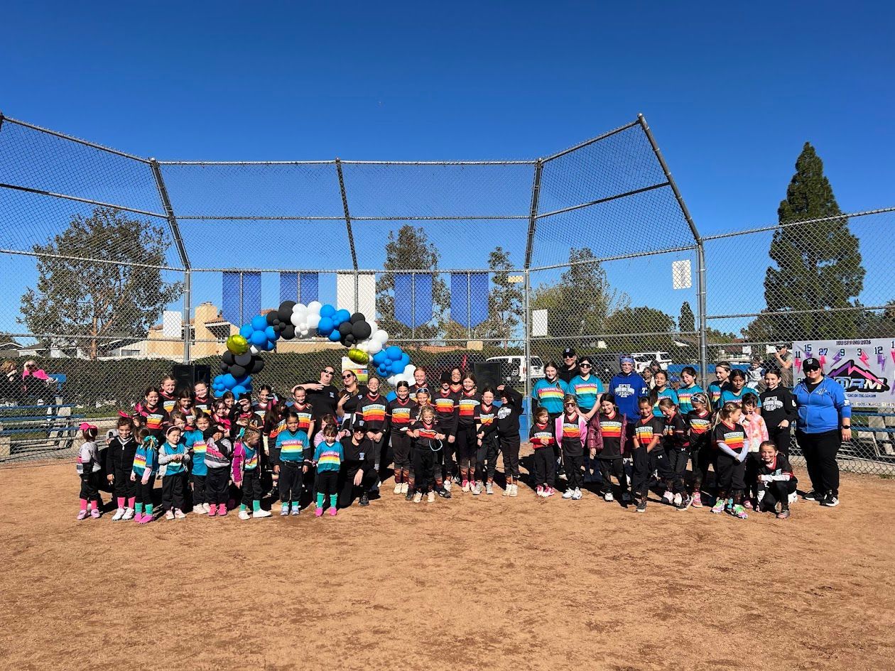 Baseball player sliding into home plate, catcher in front. Blue and gold uniforms, action shot.