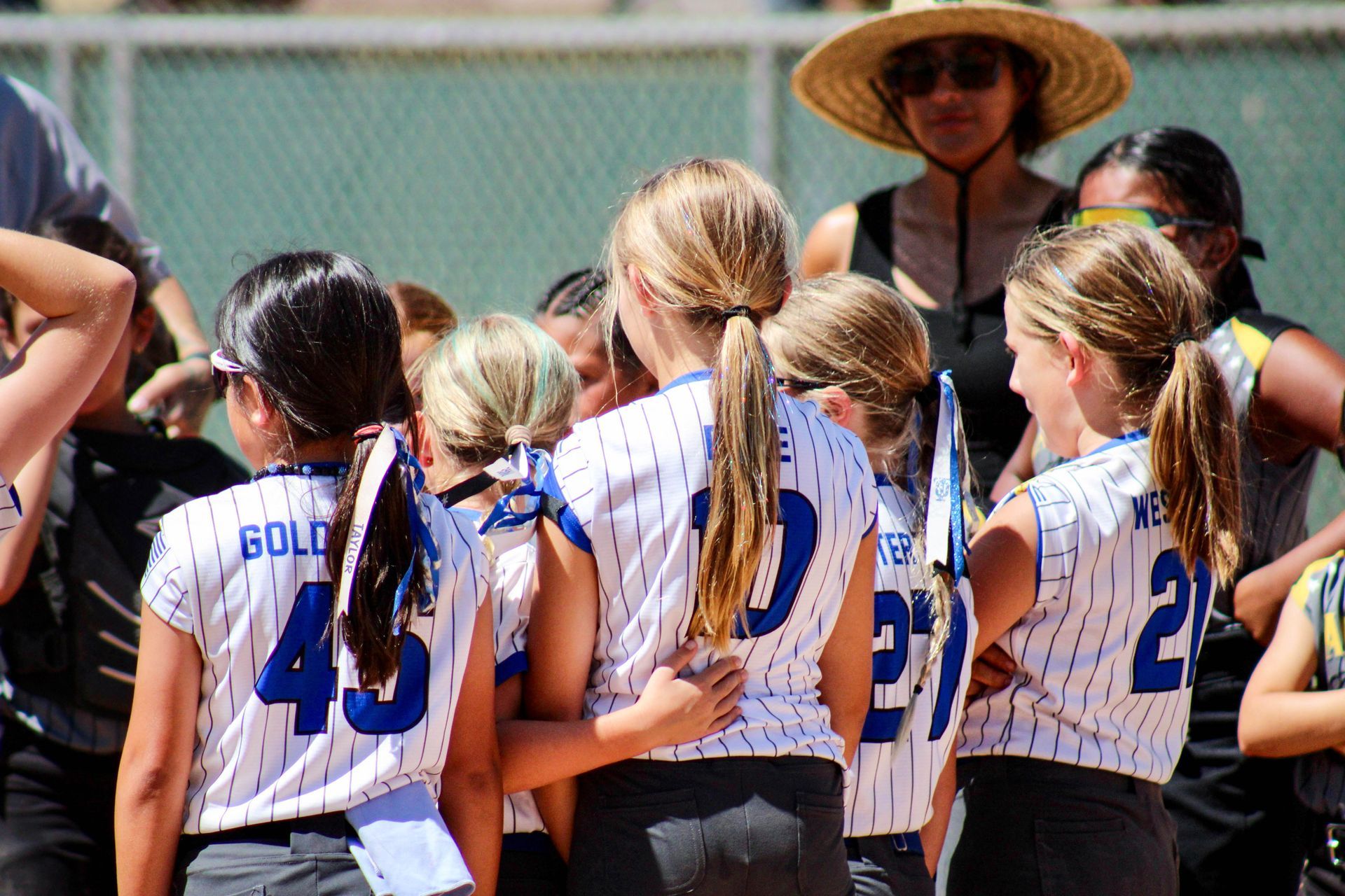 Baseball game at night, stadium filled with fans. Players on the field under bright lights. Scoreboard visible.