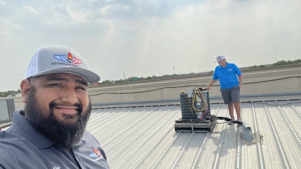 A man and a woman are working on a roof.