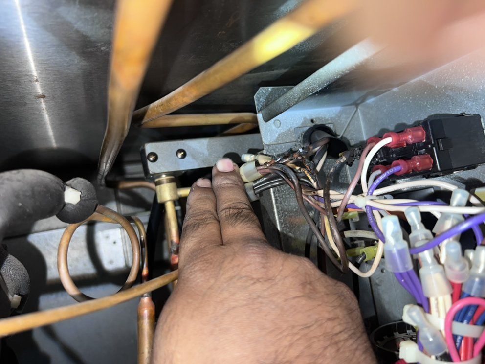 A person is working on a machine with a lot of wires