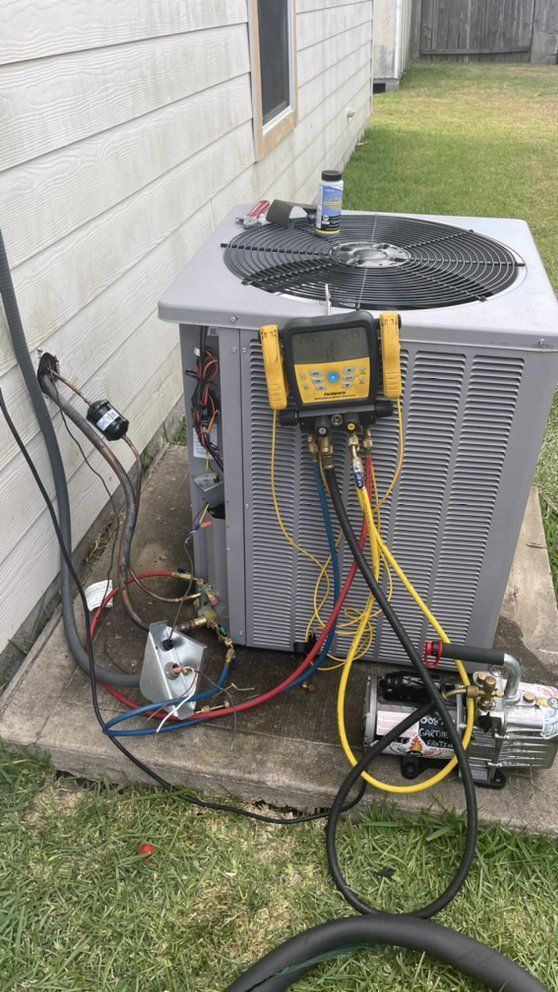 An air conditioner is being installed on the side of a house.
