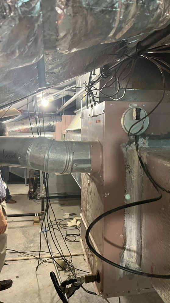 A man is working on a machine in a basement.