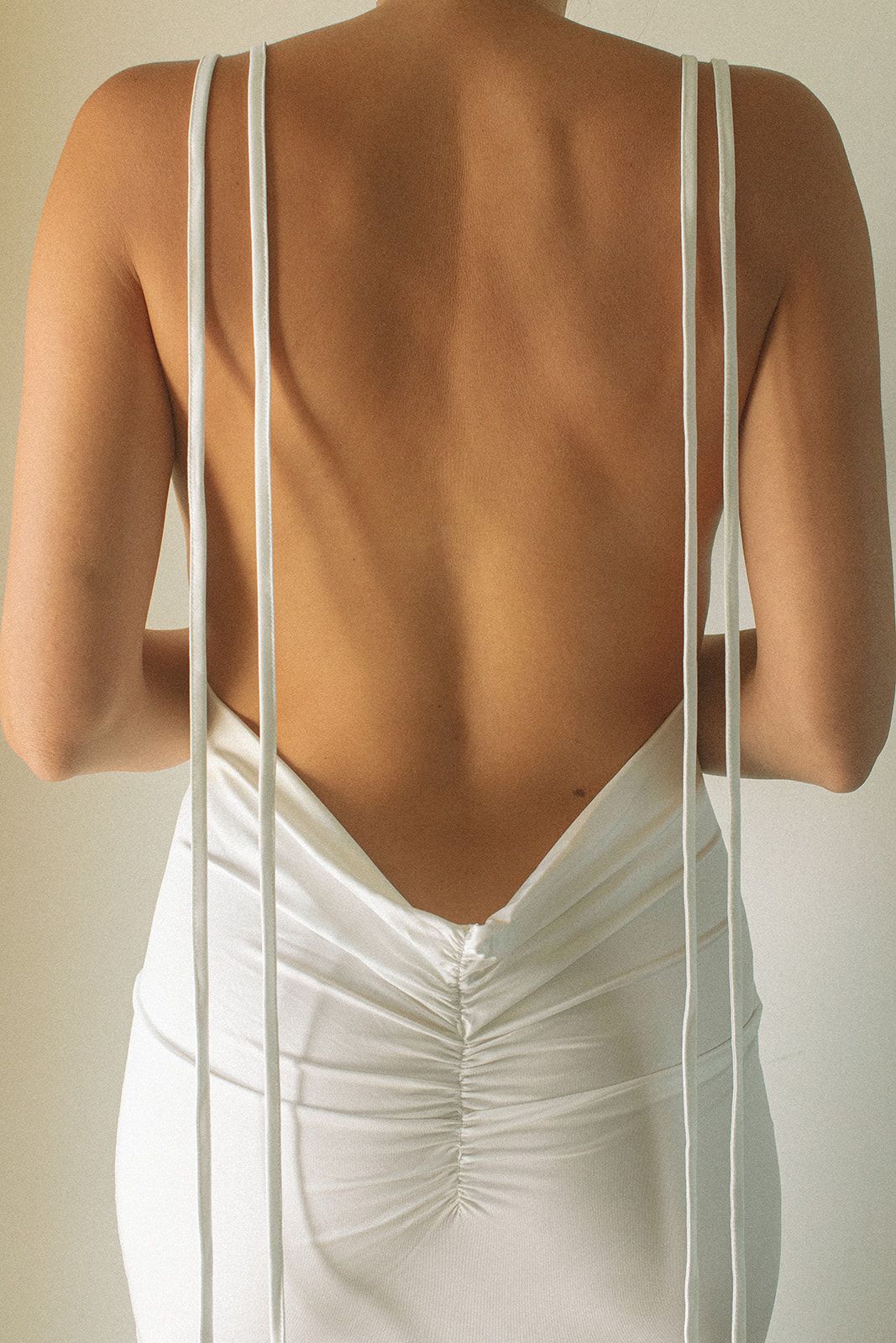The back of a woman wearing a white dress