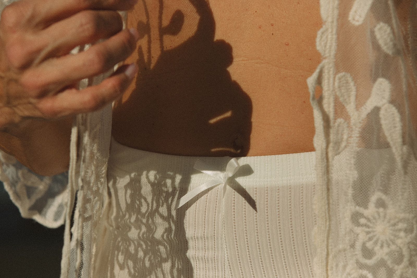 A woman in white underwear is posing for a picture.