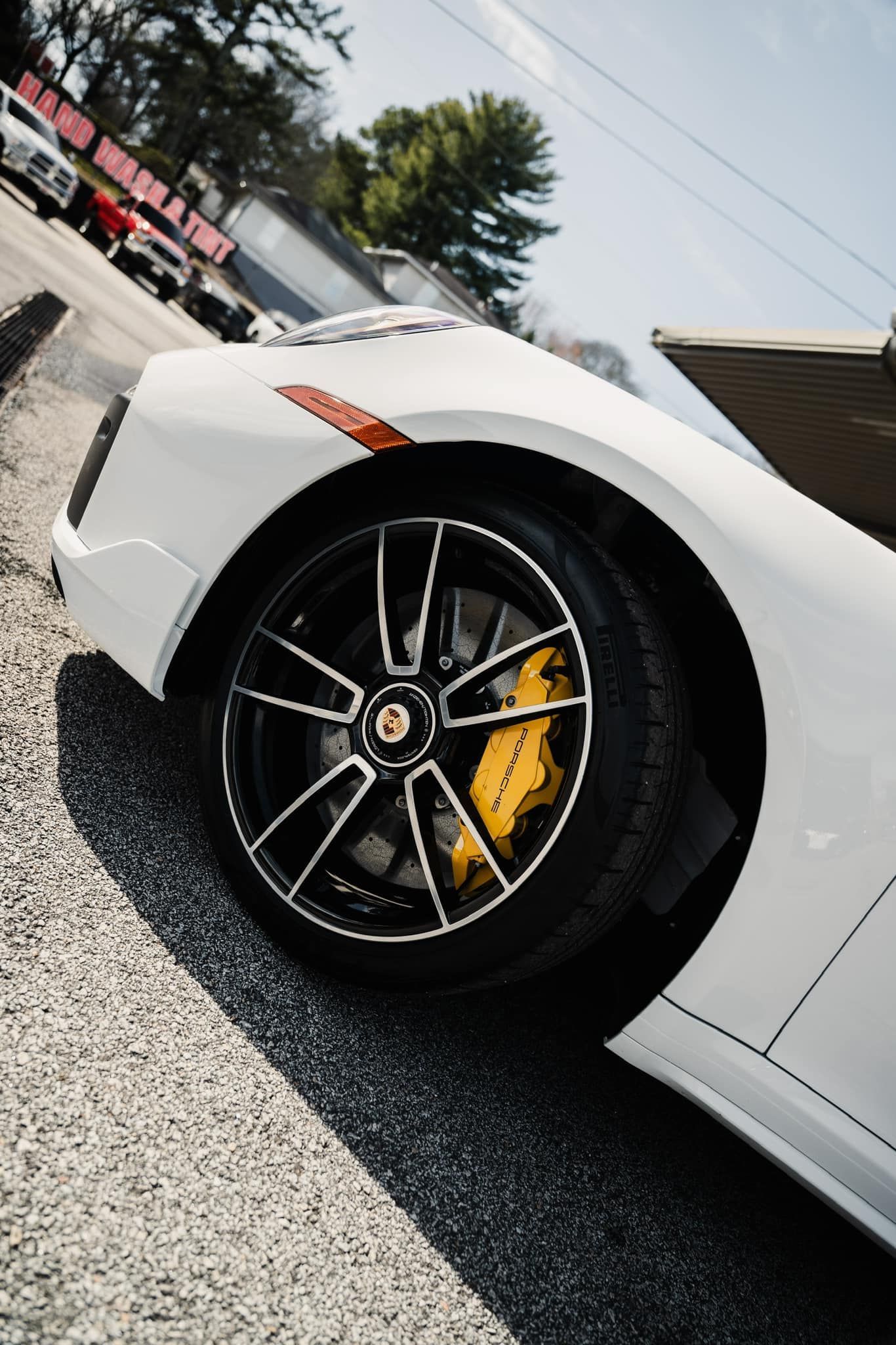 A black pickup truck is parked in a parking lot in front of a building.