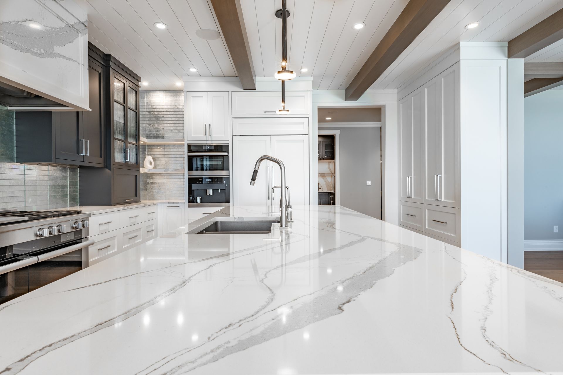 A kitchen with a large island and a sink.