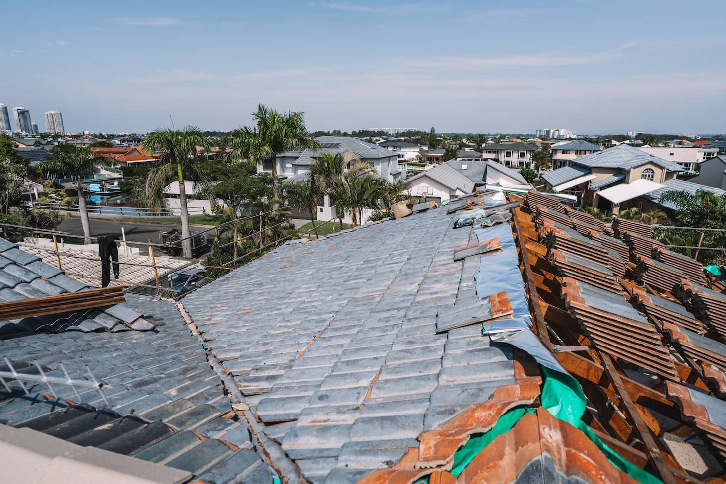 A roof with a lot of tiles on it and a city in the background.