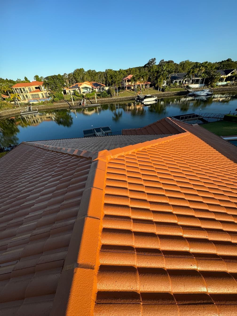 The roof of a house with a view of a lake.