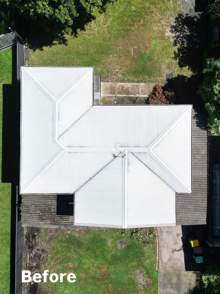 A person is standing on the roof of a house.