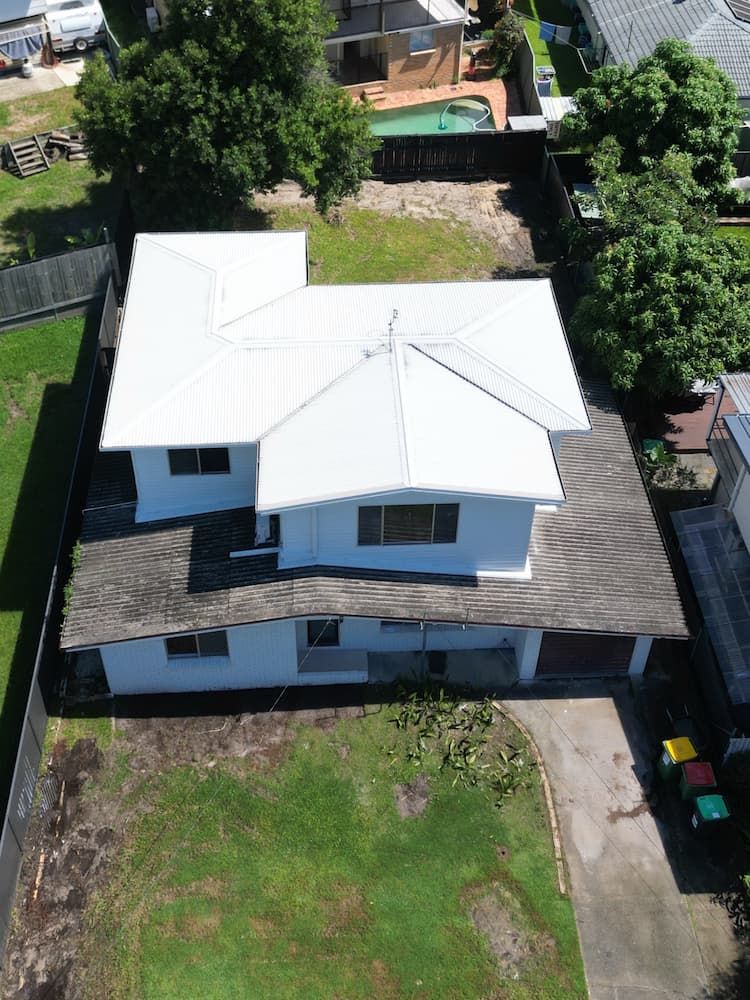 The roof of a house is being repaired and a gutter is being installed.