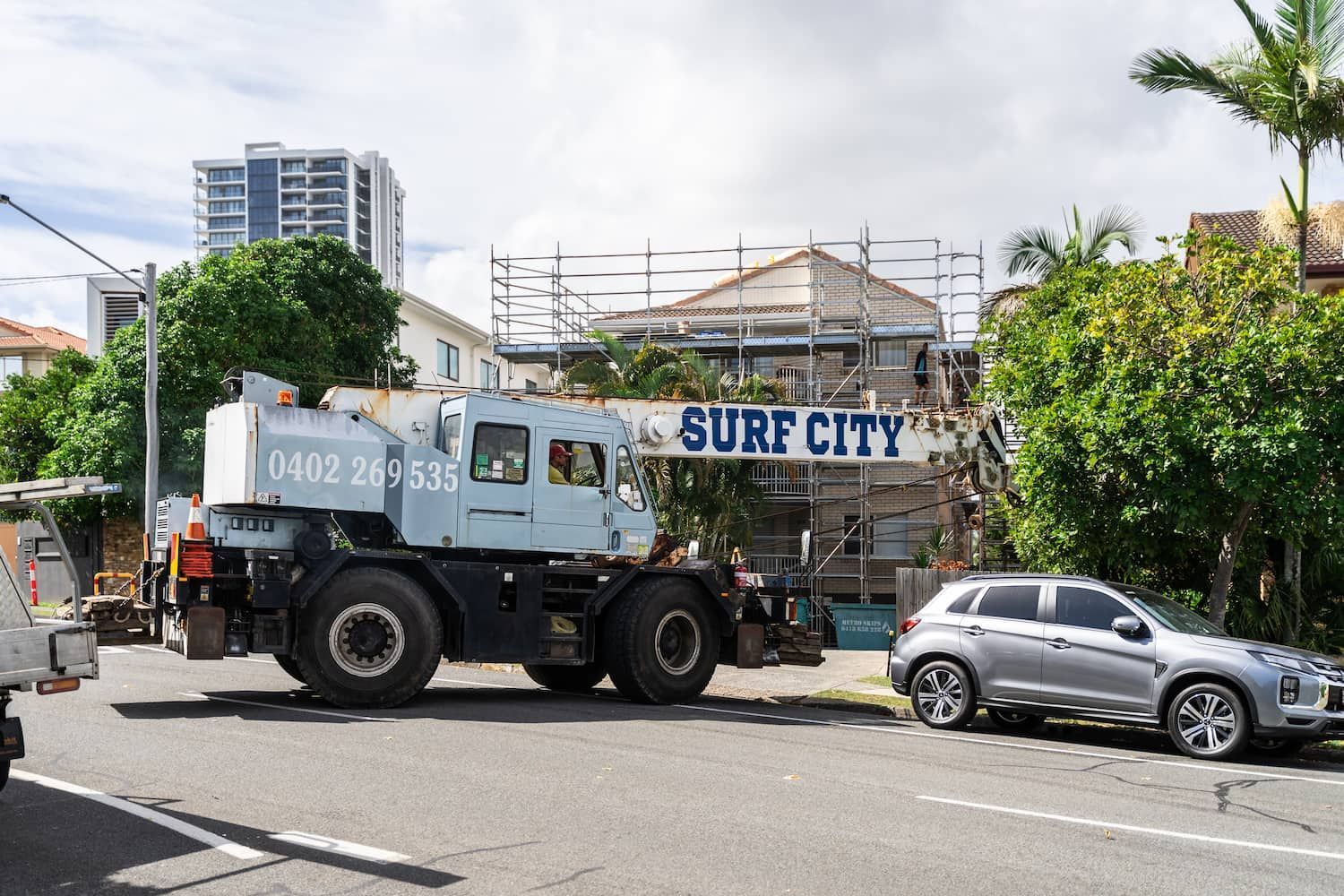 A large light-blue crane marked