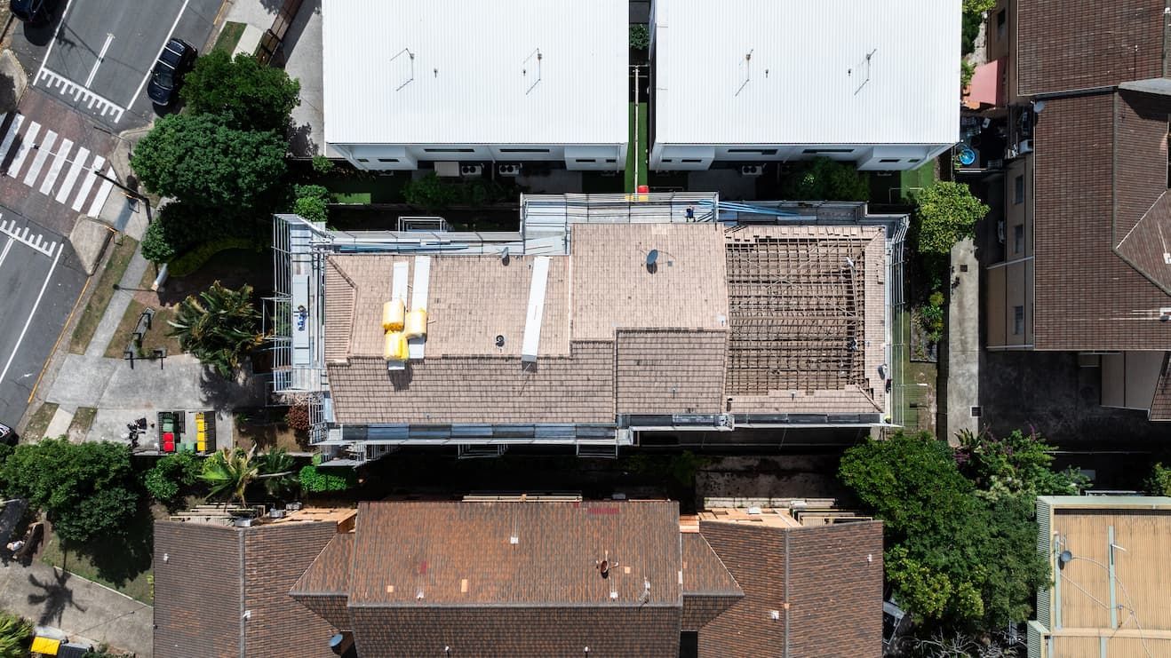 An aerial view of a roof with a sunset in the background.