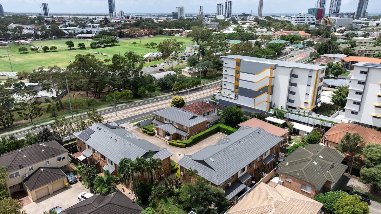 An aerial view of a residential area with a large house in the middle.