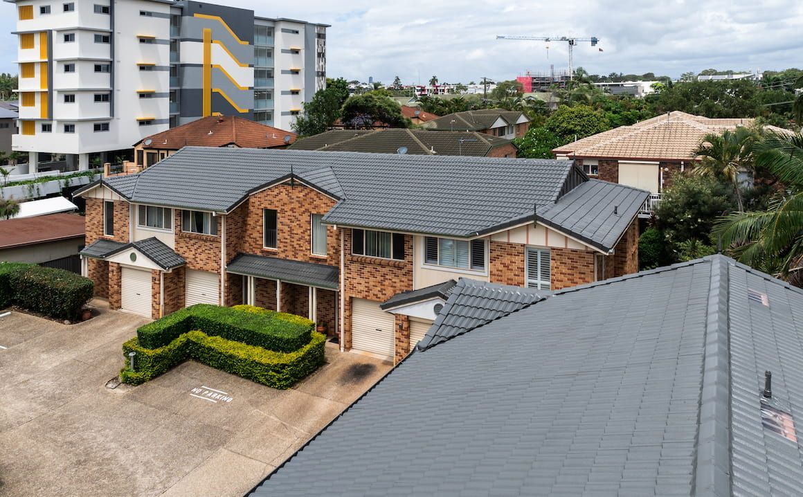 An aerial view of a large house with a tiled roof.