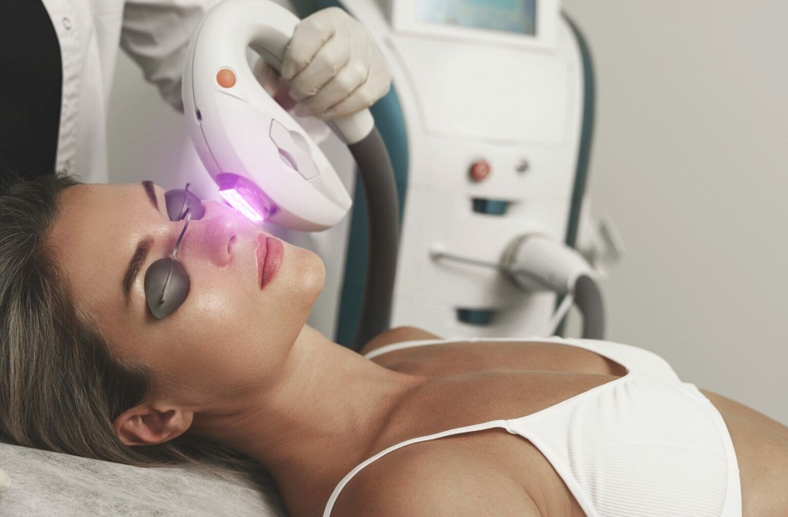 Woman having IPL procedure on her face