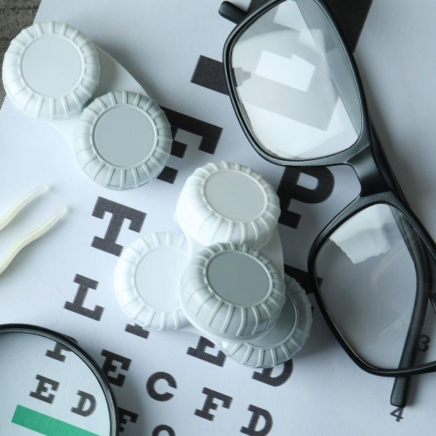 Contacts, glasses, and eye chart screen representing what vision insurance providers currently provide and visionvantage