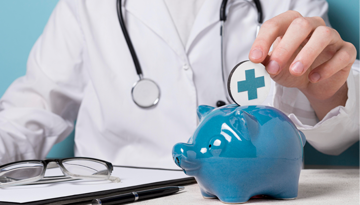 A doctor inserting a coin into a blue piggy bank.