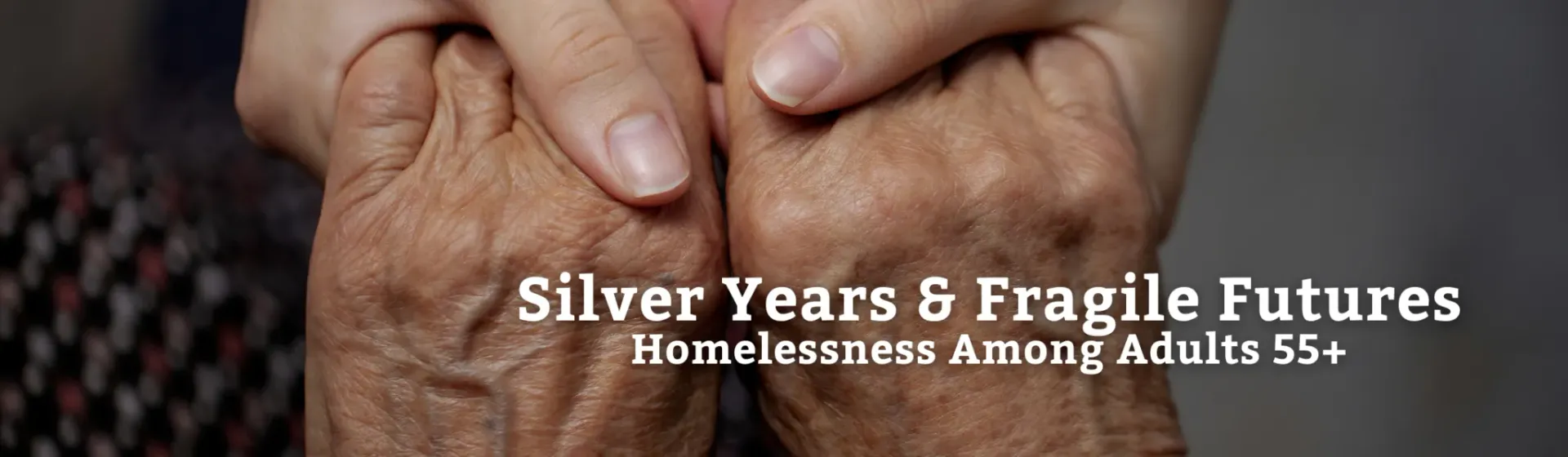 Two hands, one older, holding the other. Text: