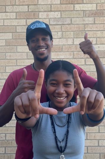 Person serving food to another person at a food bank.