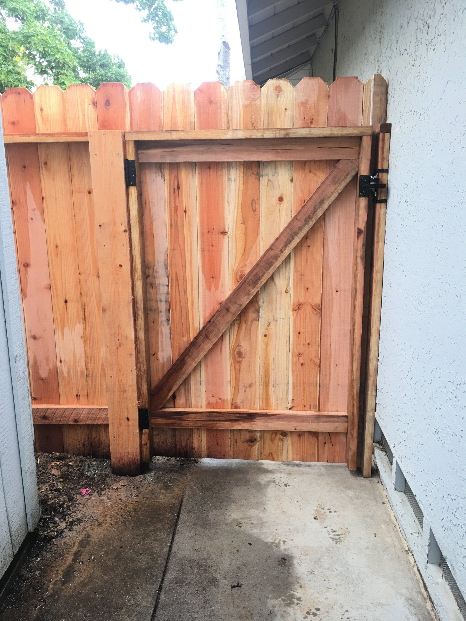 A wooden fence with a gate attached to it