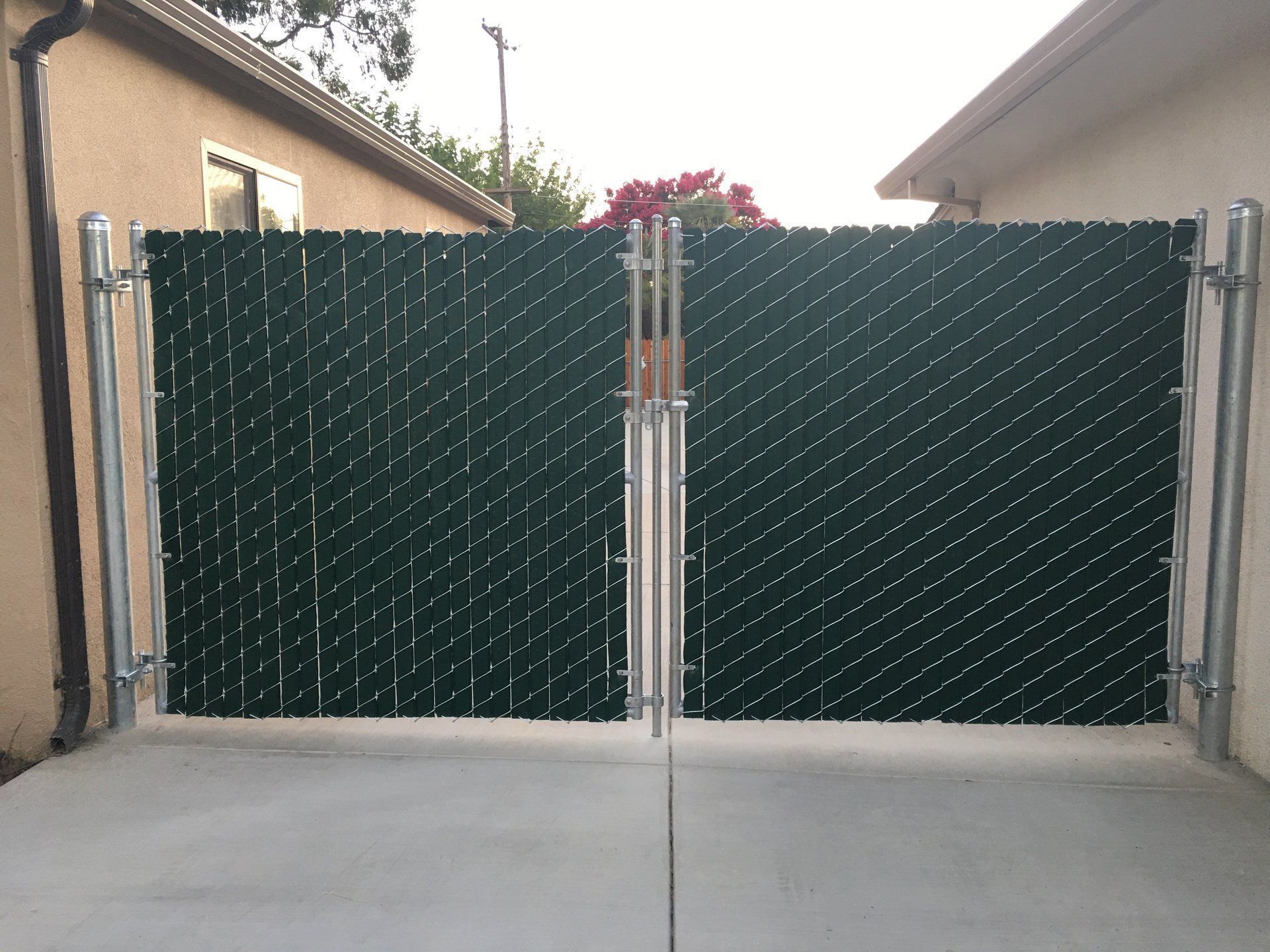 A chain link fence with a green slat