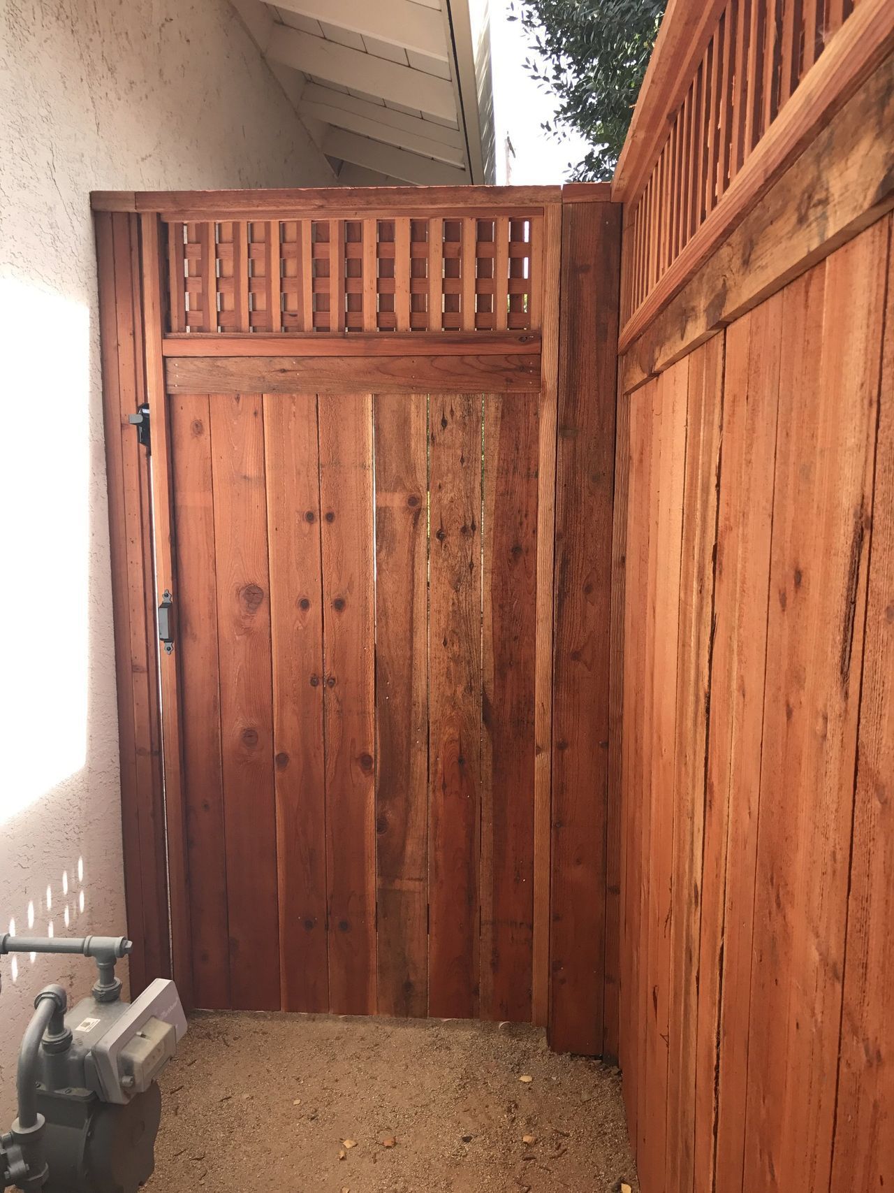 A wooden fence with a door in the middle of it