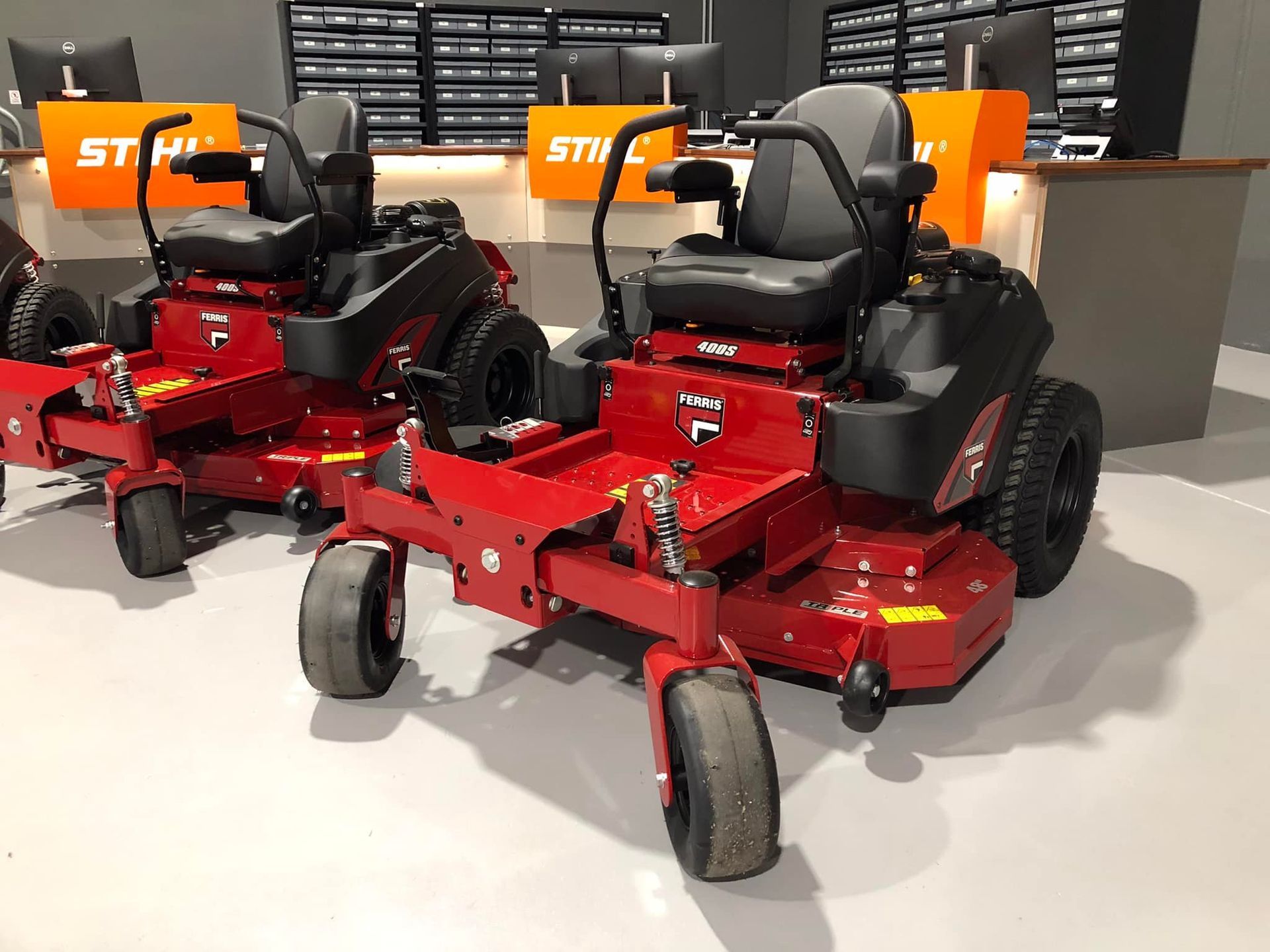 Two Red and Black Lawn Mowers Are  in a Store — Coffs Chainsaw and Mower in Coffs Harbour, NSW