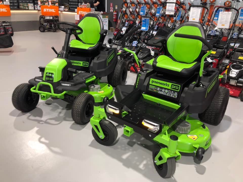 Two Green Lawn Mowers Are Sitting Next to Each Other in a Store — Coffs Chainsaw and Mower in Coffs Harbour, NSW