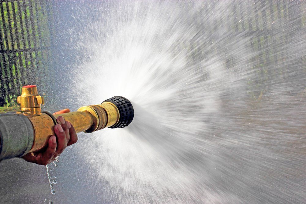 Water Spurting from Fire Hose — Coffs Chainsaw and Mower in Coffs Harbour, NSW