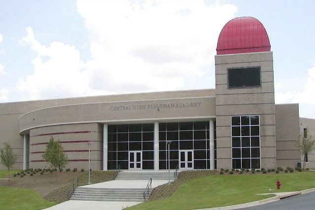 Building with red dome and glass doors. 