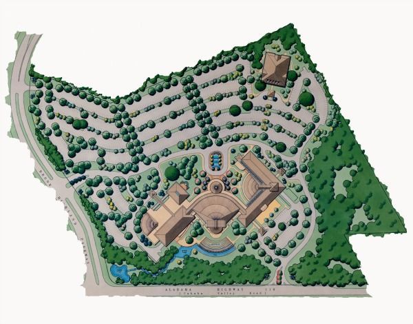 Overhead view of a building complex surrounded by parking, trees, and a roadway; brown buildings and blue water features.