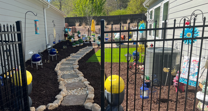 RC Landscapes' creation of a children's play area with decorative stone path.