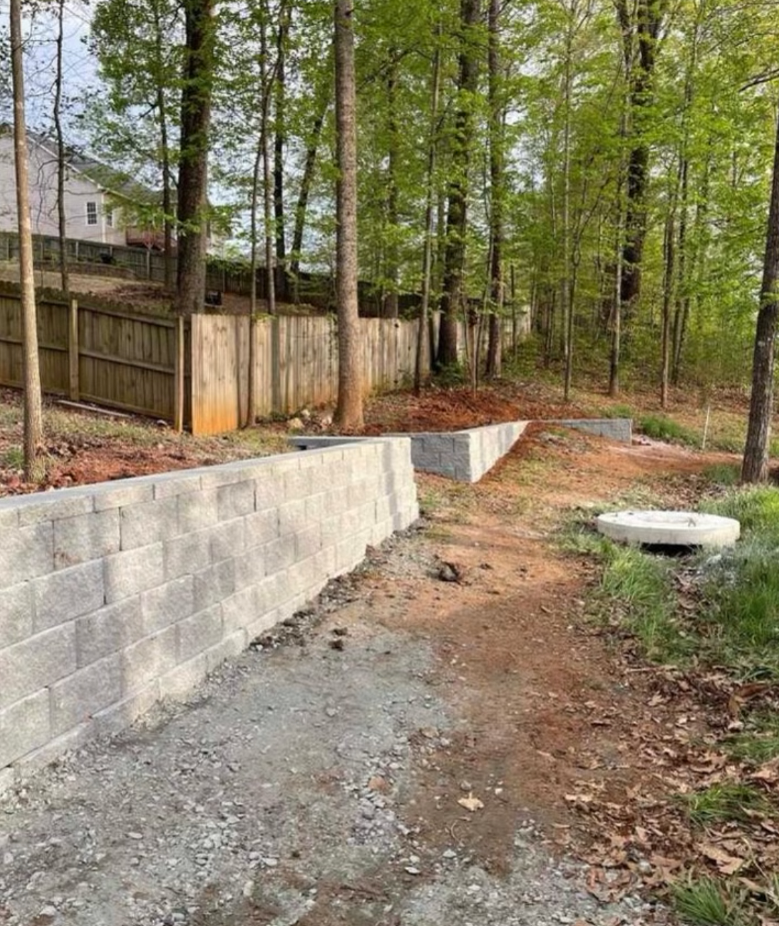 Concrete retaining wall built by RC Landscapes in a residential garden.