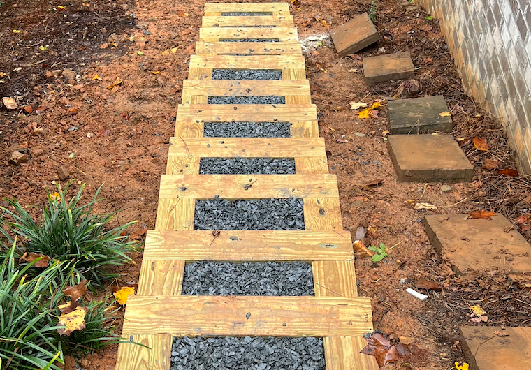 RC Landscapes laying a classic wooden sleeper and gravel pathway.