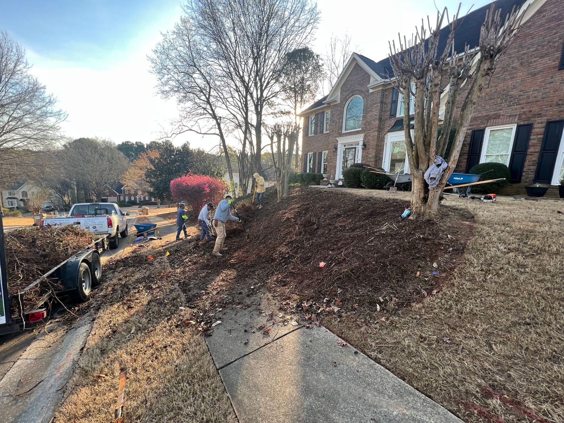 RC Landscapes team preparing a suburban lawn for new landscaping.