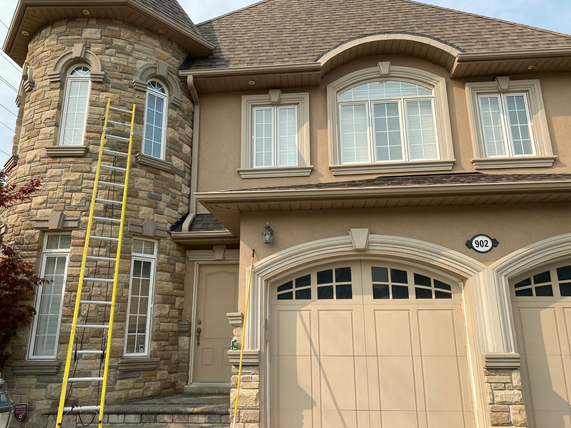 A large house with a ladder in front of it.