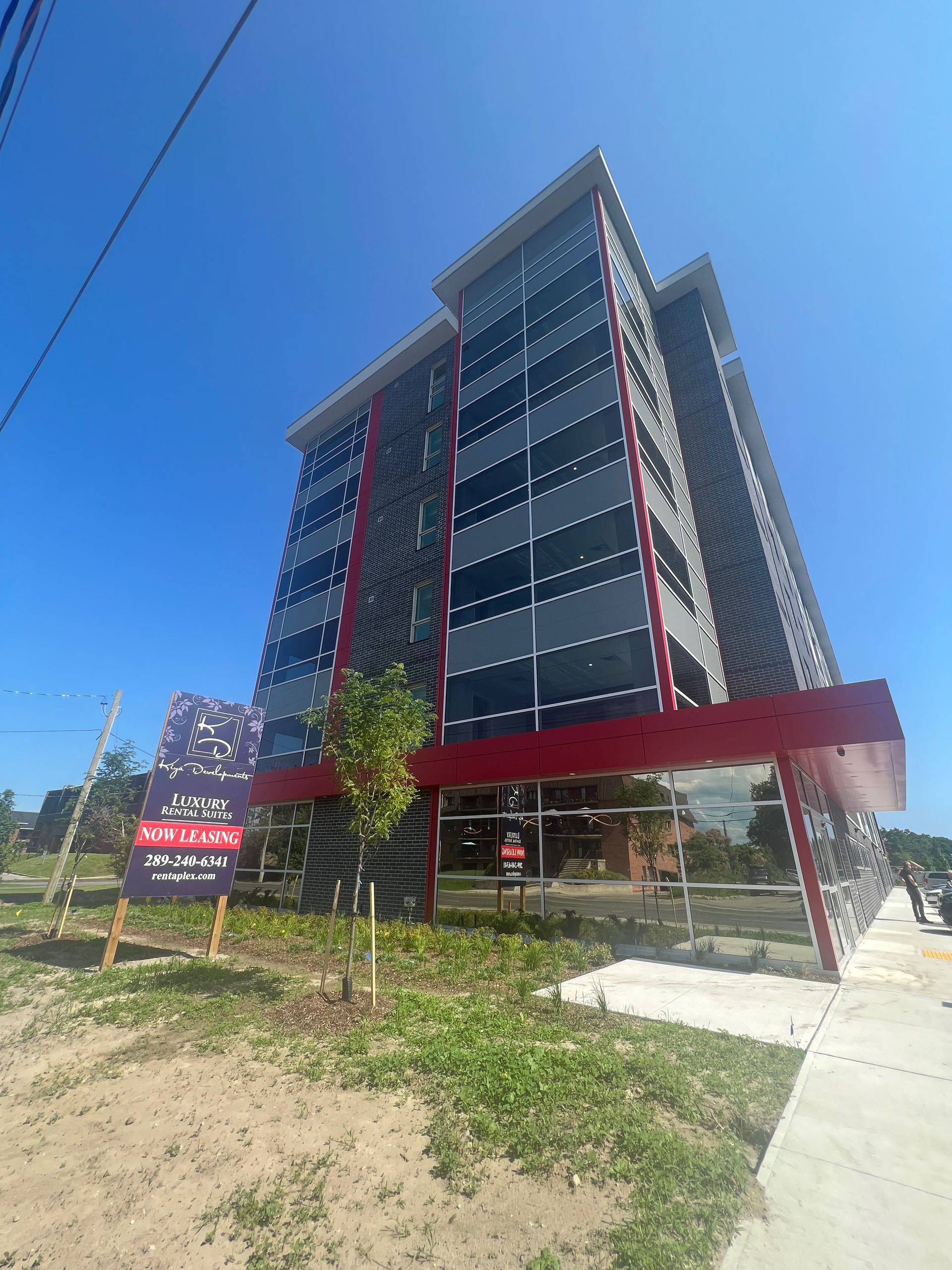 A large building with a lot of windows is for sale.