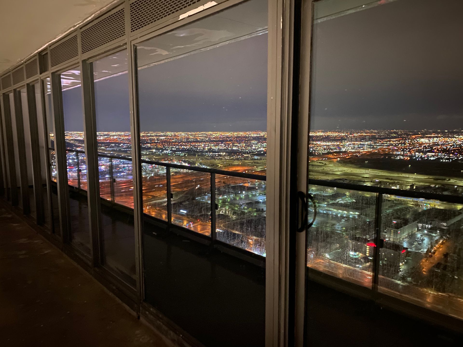 A balcony with a view of a city at night.