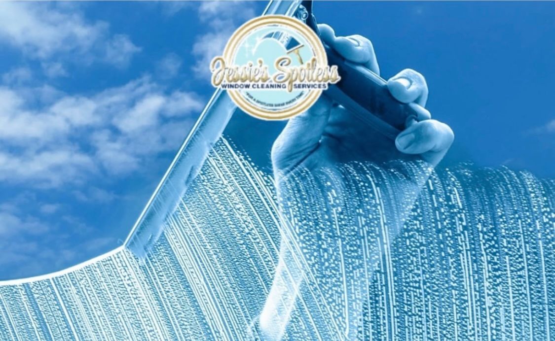 A person is cleaning a window with a squeegee.